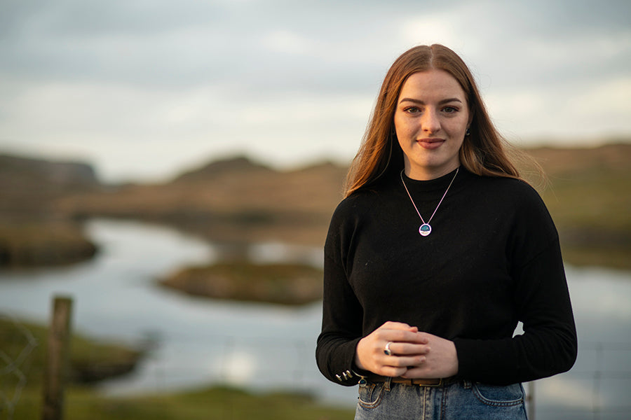 Bethany wearing a landscape piece of jewellery in the location it's based upon, Clousta