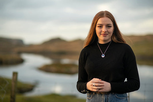 Bethany wearing a landscape piece of jewellery in the location it's based upon, Clousta
